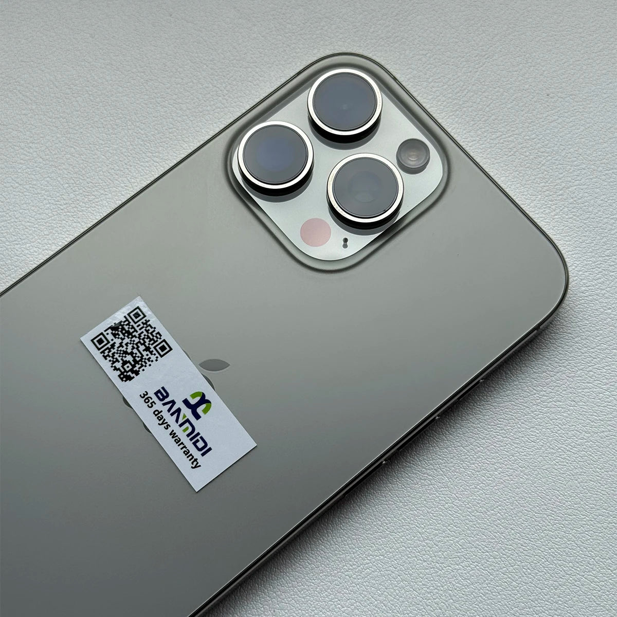 Apple iPhone 16 Pro Max 256GB unlocked in silver showing rear triple camera and warranty sticker