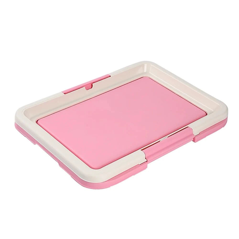 Pink and white indoor potty for small dogs with a removable tray for easy cleaning