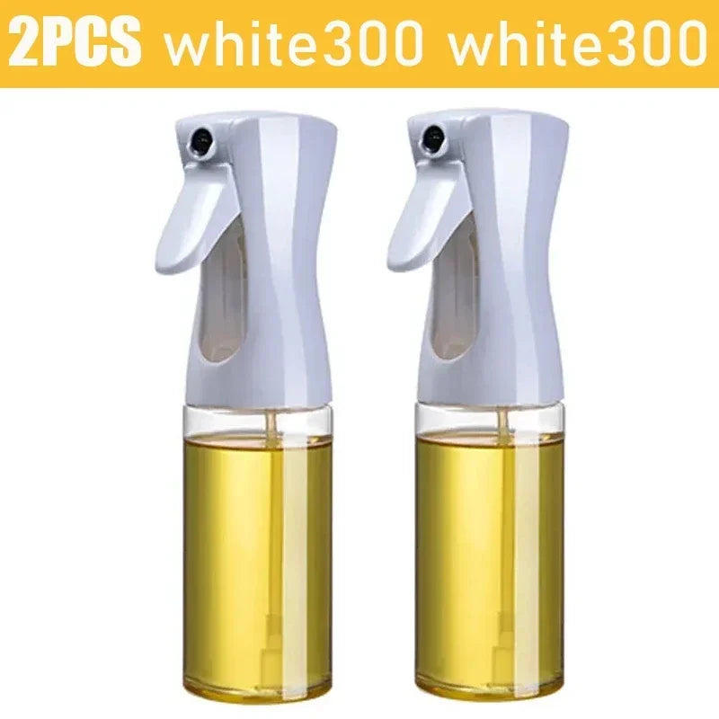 Set of 2 kitchen oil dispenser sprayer bottles with white spray tops and clear containers filled with oil