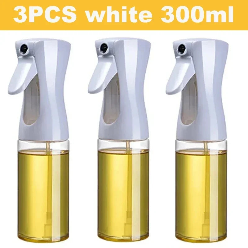 Set of three white 300ml kitchen oil dispenser sprayers with clear containers filled with oil