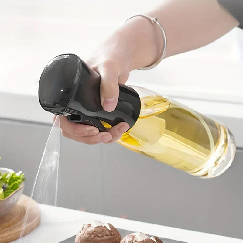 Merit Sell kitchen oil dispenser sprayer in use pouring oil over food with ergonomic black handle