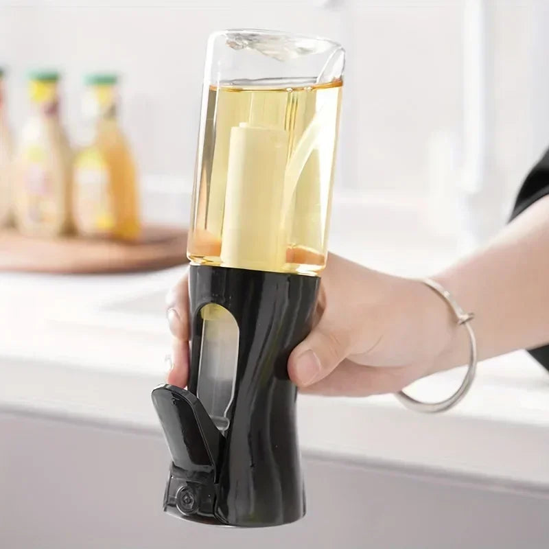 Merit Sell kitchen oil dispenser sprayer held in hand with clear container and black base