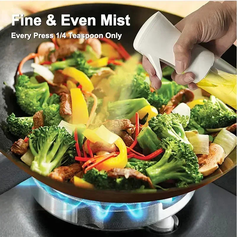 Merit Sell kitchen oil dispenser sprayer releasing fine mist over stir fry vegetables on stovetop