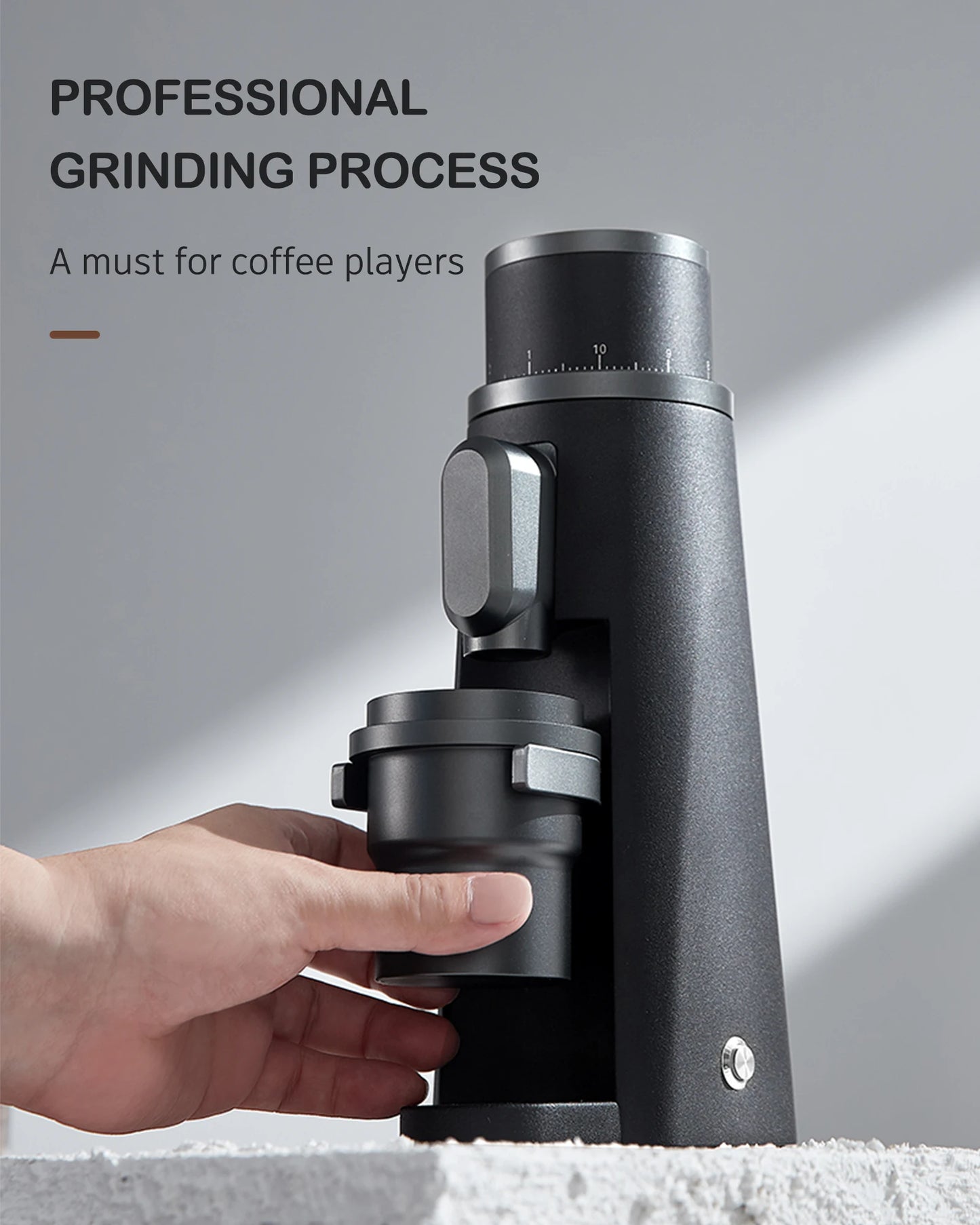 Merit Sell electric coffee grinder with titanium burrs in black with hand removing ground container