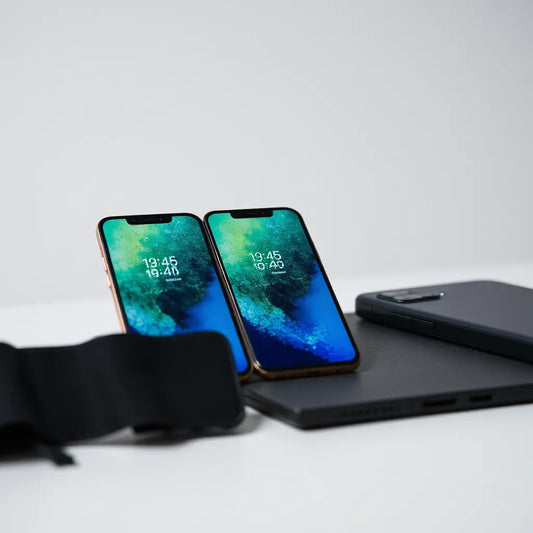 Three premium mobile phones displayed on a minimal desk with vivid screens