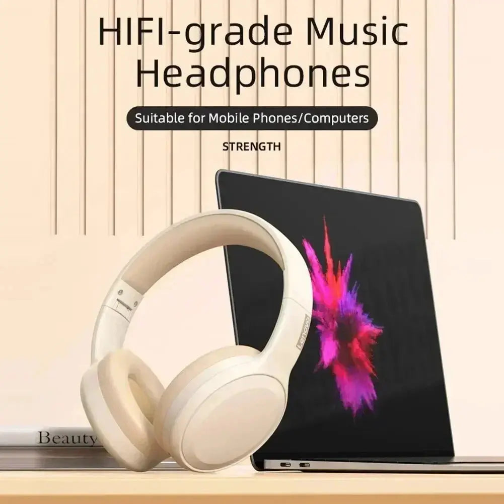 Beige HIFI-grade music headphones on a wooden surface with a laptop in the background.