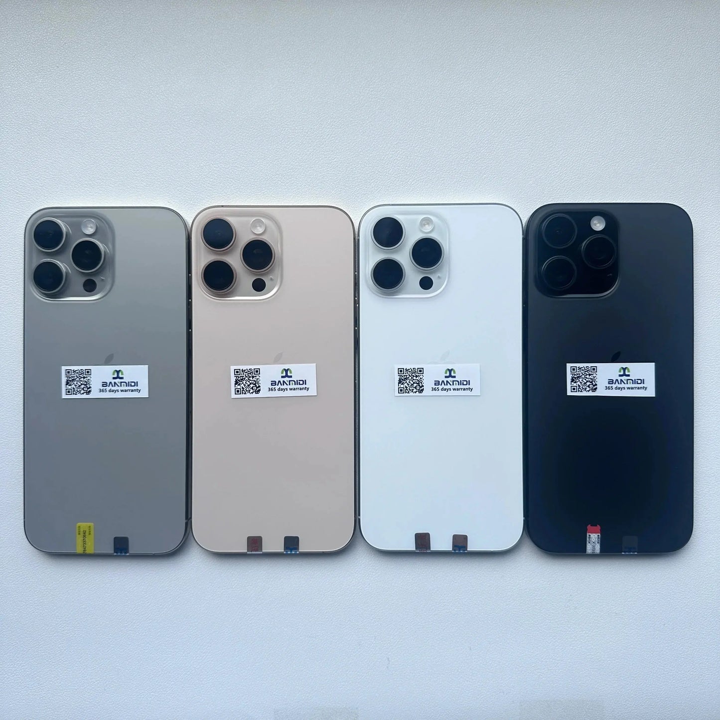 Four Apple iPhone 16 Pro Max 256GB unlocked smartphones in different colors displayed from back by Merit Sell