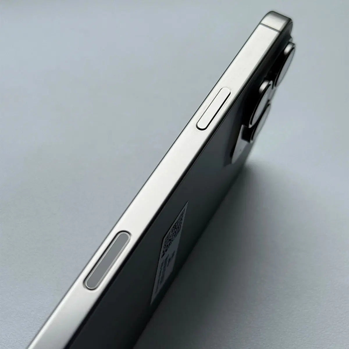 Close-up side view of Apple iPhone 16 Pro Max 256GB unlocked showing volume and power buttons in silver finish