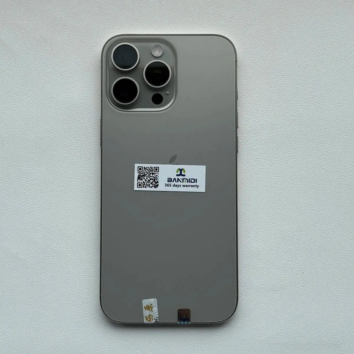 Apple iPhone 16 Pro Max 256GB unlocked in silver showing the back with triple camera setup and warranty sticker