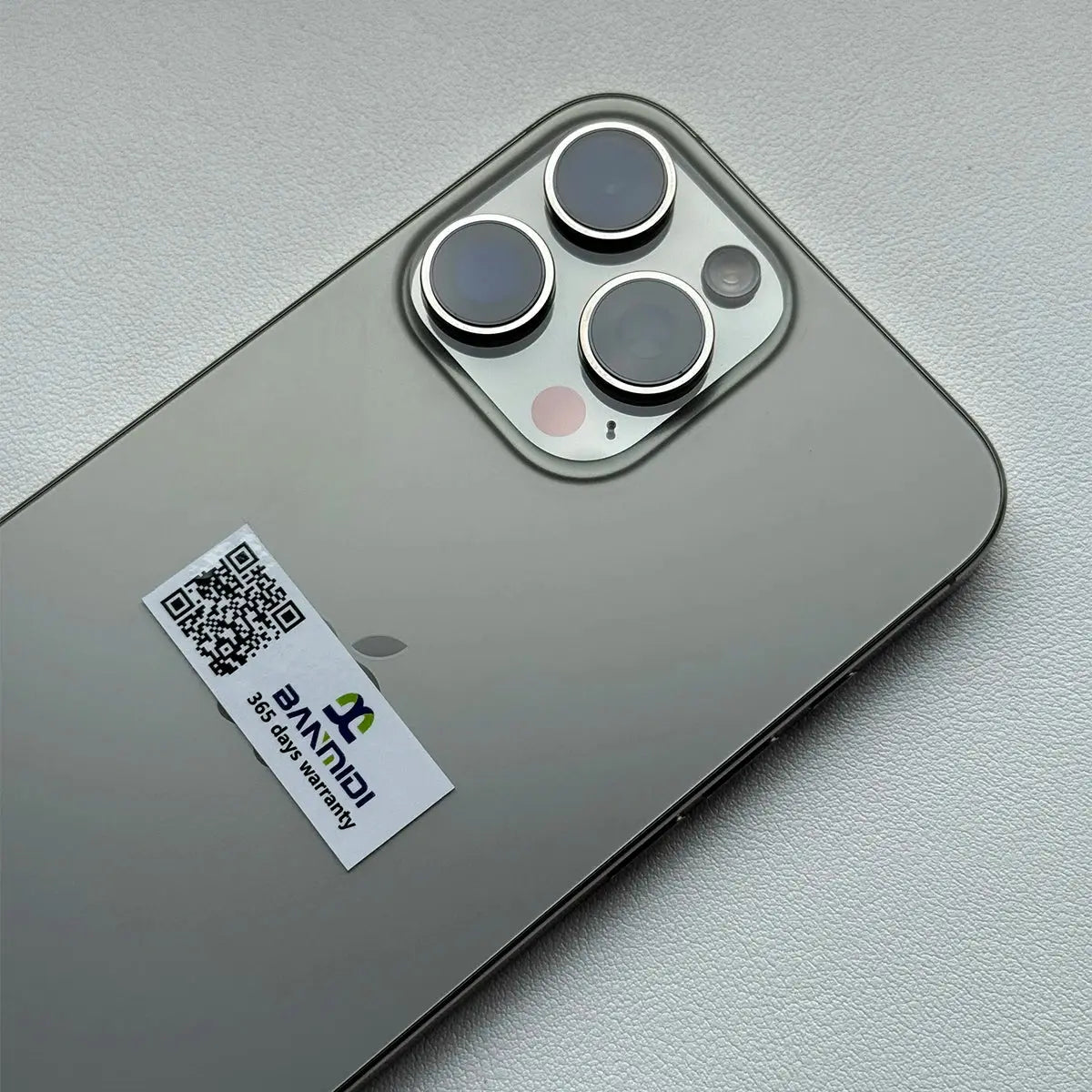 Apple iPhone 16 Pro Max 256GB unlocked shown from back with triple camera lenses and warranty sticker
