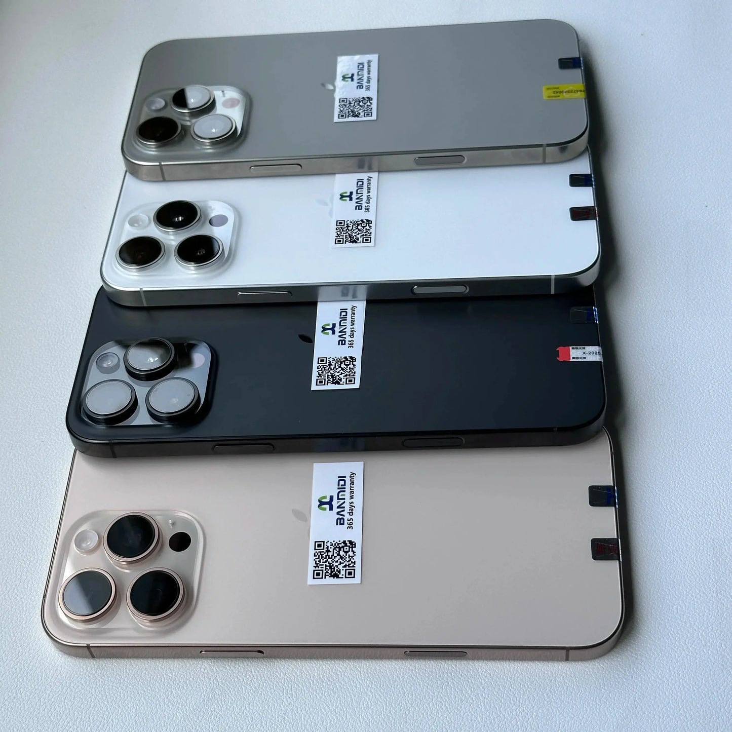 Unlocked iPhone 16 Pro Max for sale in four colors arranged flat with visible cameras and Merit Sell labels