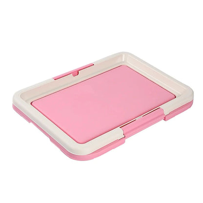 Pink and white indoor potty for small dogs with a removable tray for easy cleaning