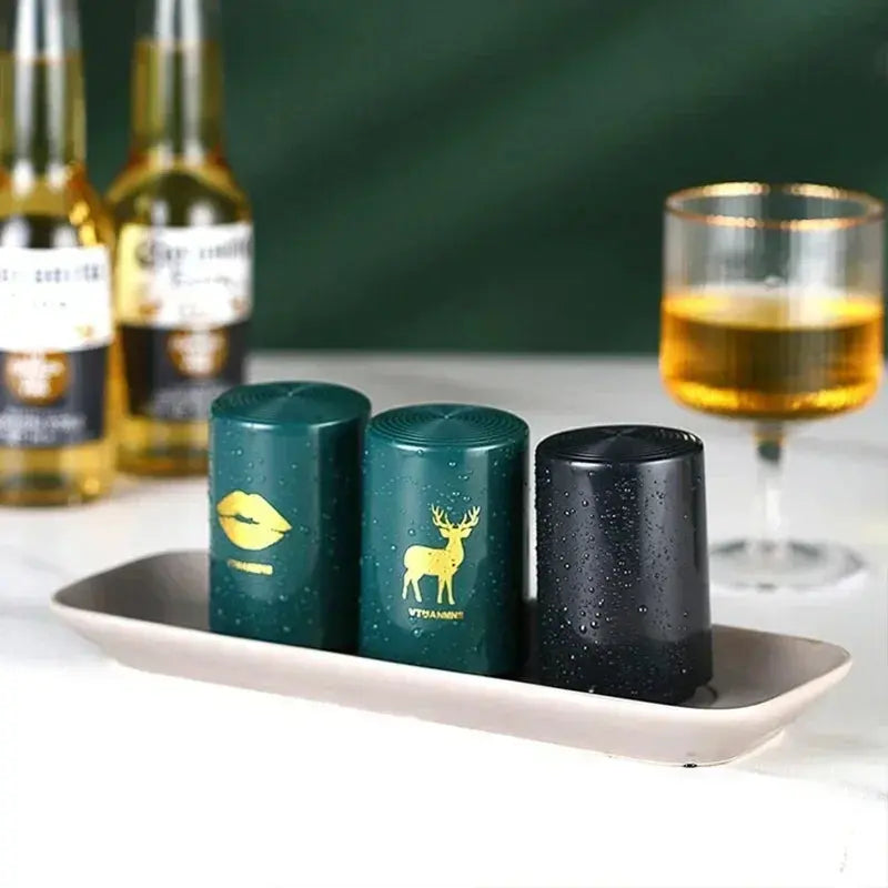 Merit Sell magnetic automatic bottle opener set with green and black designs on a tray beside bottles and a glass