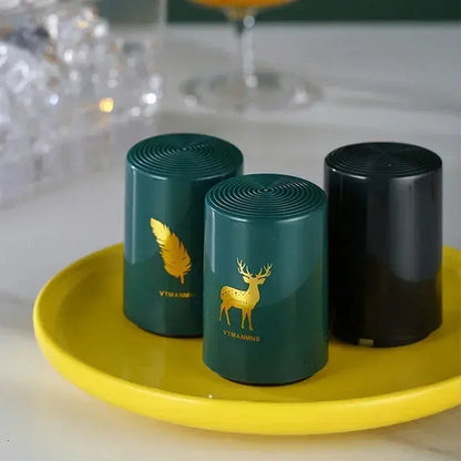 Merit Sell green and black magnetic automatic bottle opener set on yellow plate with gold designs