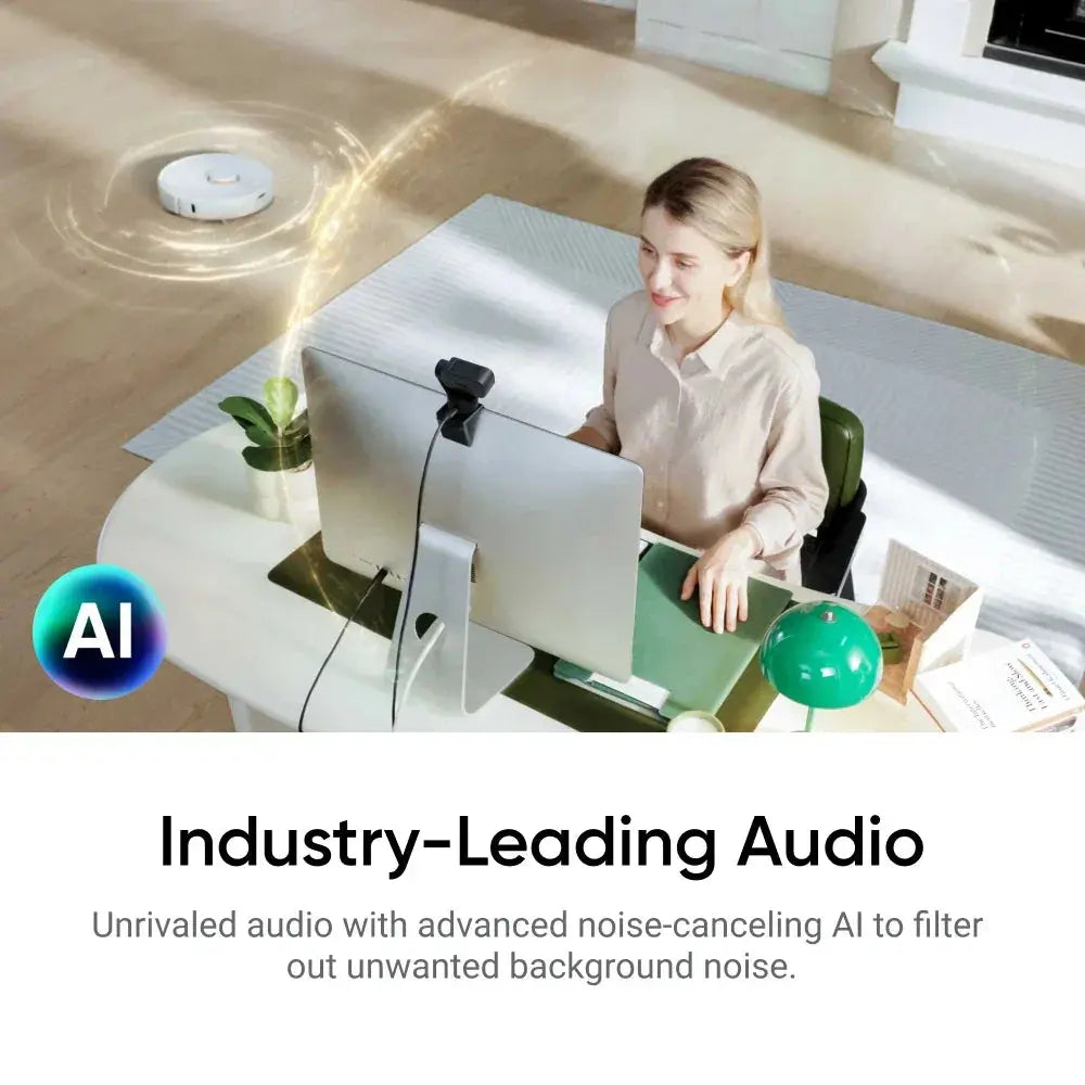 Woman using Insta360 Link 2 4K webcam on desktop computer with AI noise-canceling audio feature